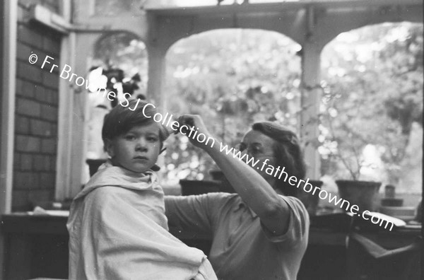 MRS R J MARTIN (ETTE) AND GRANDSON (JOHNNY)  CUTTING HIS HAIR  AT LOWOOD